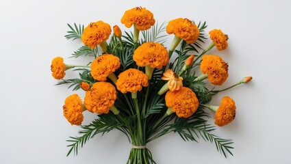 Bouquet of vibrant marigold flowers arranged with greenery on a plain background Copy Space