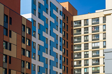 Colorful apartment building facades with modern architecture against a blue sky