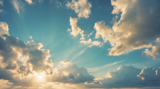 Sunset clouds with sun rays creating dramatic light in a blue sky natural background with copy space for text