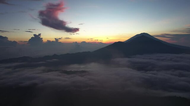 Aerial sunrise rise view of Mount Abang with low hanging cloud, Bali