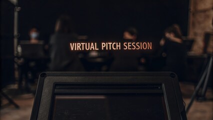 A closeup of a tablet displaying a holographic invitation to a virtual pitch session while a group of participants prepares to present their ideas in a digital setting.