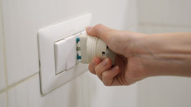The UK or SG 3 Pin Plug Power converter or travel adapter. The electrical outlet socket in the hotel room
