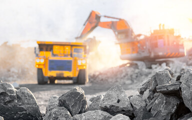 Open pit mine coal mining with heavy excavator machinery and rocky terrain, banner