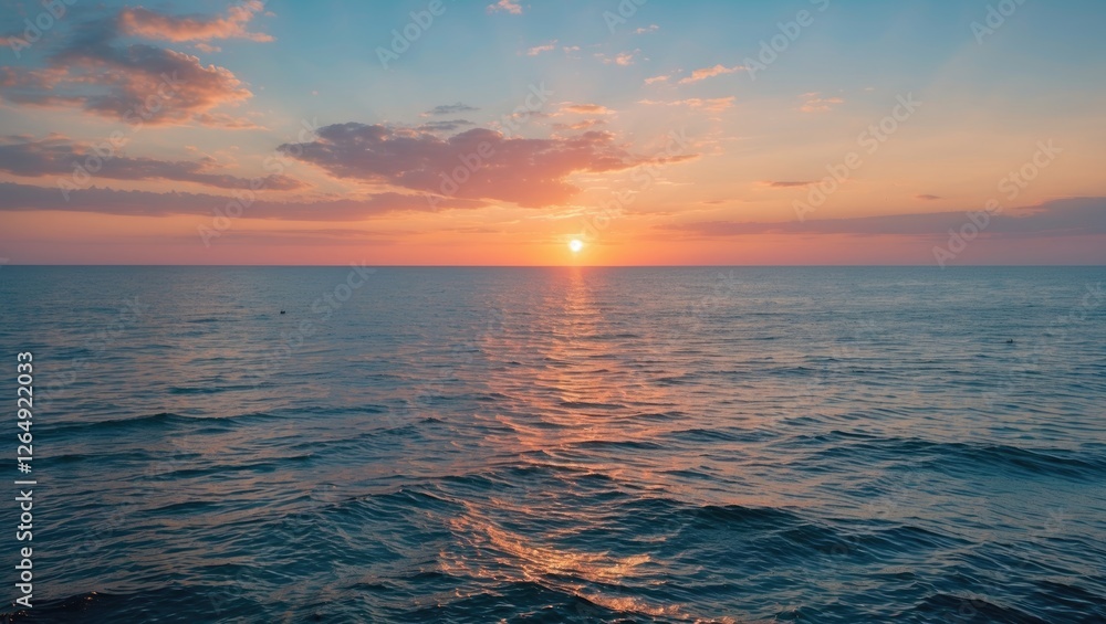 Aufkleber Sunset over calm ocean waters with colorful clouds reflecting in the sky and gentle waves in the foreground Copy Space