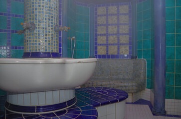 Turkish bath or steam sauna with mosaic tiles inside male locker room of spa or wellness are...