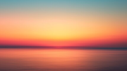 Fototapeta premium A serene sunset over calm waters, showcasing vibrant hues of orange, pink, and blue blending into the horizon.