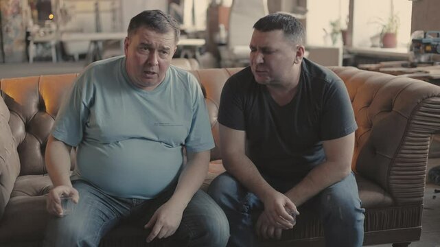 
High men feeling sick and vomiting at party, intoxicated guys relaxing on   brown sofa.High quality 4k video. Slow motion.