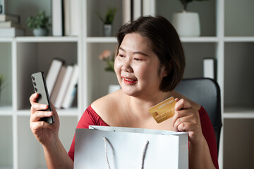 Cheerful shopper taking a selfie with her purchases and smartphone in a stylish office.