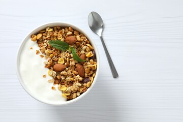 Delicious granola with yogurt on a light background