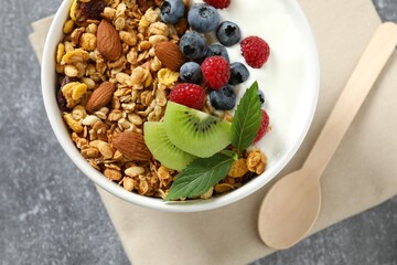 Delicious granola with berries and yogurt on a light background