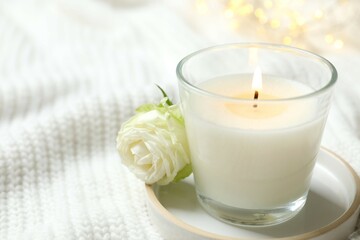 Beautiful candle on white fabric