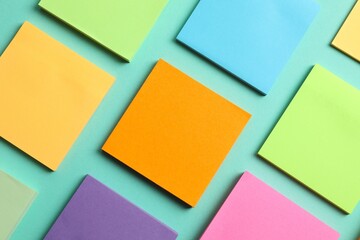 Top view of stacks of colorful sticky notes on color background 