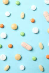 Various pills on blue background