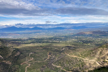 Naklejka premium Hiking on trail along abandoned open-pit mine and burnt trees near Mijas, Spain 