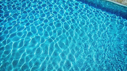 Obraz premium Drone captures mesmerizing azure pool; ripple waves dance on a serene blue water surface.