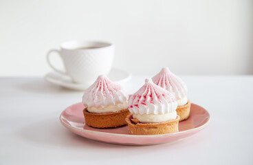 cupcakes with cup of coffee on white table