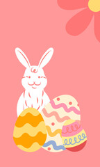 White easter bunny sitting behind colorful decorated eggs on pink background