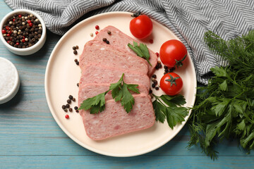 Pieces of tasty canned meat, parsley, peppercorns and tomatoes on light blue wooden table, flat lay