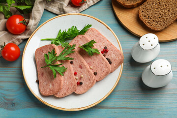 Tasty canned meat, spices, bread and tomatoes on light blue wooden table, flat lay