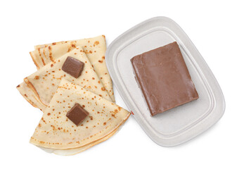 Tasty crepes with chocolate butter isolated on white, top view