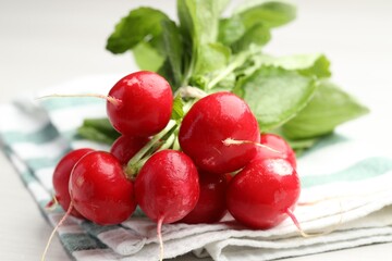 Bunch of fresh radishes on white table, closeup