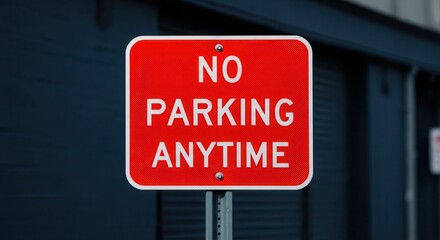 Obraz premium Red No Parking Anytime Sign with White Letters on Metal Post