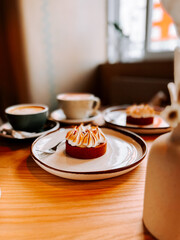 Enjoying coffee and dessert at a cozy cafe in the morning with a warm ambiance