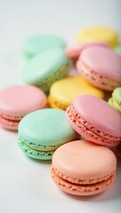Fototapeta premium Pastel-colored macarons scattered on a white surface, desserts, culinary art