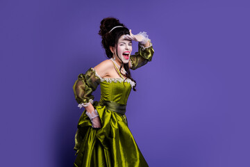Elegant woman in vintage green gown and gloves posing against purple background embodying...