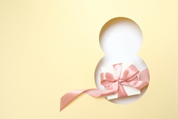 8 March greeting card design with gift box, top view. Happy International Women's Day