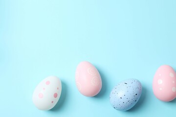 Happy Easter. Colorful eggs on a pastel blue background, space for text or advertising