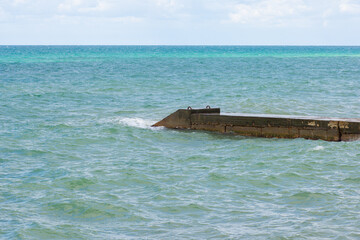 Naklejka premium Breakwater structure coastal area to protect against tides, currents, waves, and storm surges