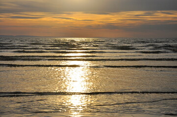 Seascape. Sandy seashore at sunset at low tide