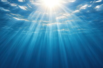 Fototapeta premium Tranquil Underwater Scene with Sunlight Rays Illuminating Deep Blue Water Surface