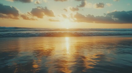Fototapeta premium A stunning sunset paints the horizon with vibrant hues as gentle waves reflect the golden sky, creating a serene and picturesque seascape.