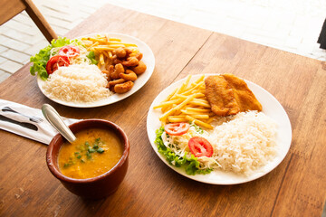 lunch with a dish made in a popular Brazilian seafood restaurant with breaded pirão fish and shrimp