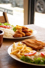 lunch with dish made in a popular Brazilian seafood restaurant with breaded shrimp and fish salad