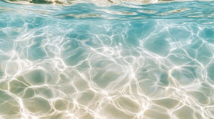 Obraz premium Sunlight dances on clear turquoise water, creating a mesmerizing pattern, inviting reflections and calm.