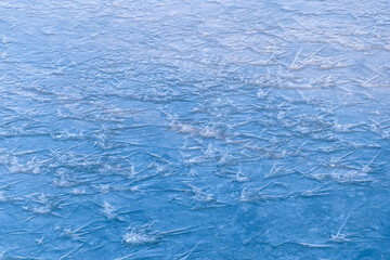 A frozen surface with intricate ice crystal patterns. Ice texture.