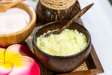 Natural spa body scrub with organic ingredients in coconut shell bowl for skincare