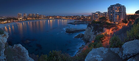 Fototapeta premium Coastal city lights at dusk