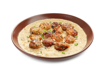 Delicious meatballs with gravy cream sauce and herbs isolated on white