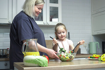 Mom passes on family culinary traditions to her daughter by cooking vegetables together