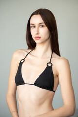 Fototapeta premium Professional model test shoot for agency submission. Natural beauty, minimal makeup, black bikini, clean background, confident poses. Perfect for portfolios, castings, and fashion industry needs