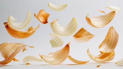 Fresh onion slices fall elegantly against a bright white backdrop, showcasing their vibrant colors and textures. This dynamic motion captures the essence of cooking and freshness