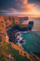 Dramatic sunset over rugged coastline, cliffs, ocean waves crashing against rocks.