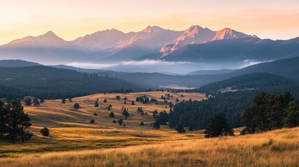 Obraz premium Sunrise over mountain range, valley, and grassland.