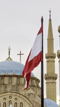 Beirut, Lebanon 01 26 2025: Al Amin mosque with blue domes and Christian church with a cross in downtown Beirut. Lebanese flag prominent. Diversity, religious coexistence, national identity. Vertical