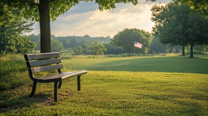 Fototapeta premium A serene view of an empty bench in a Memorial Day park, the American flag visible in the background 