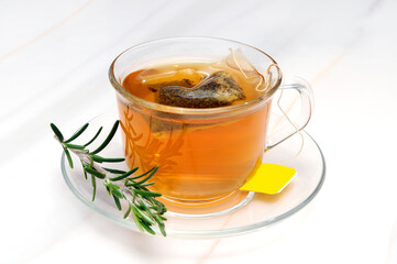 Glass of Tea with a Tea Bag and Rosemary on a Cup Tray